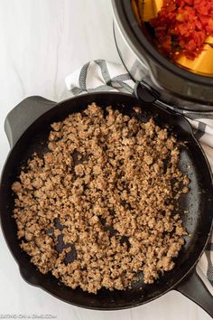 the crock pot is filled with ground beef and tomato sauce next to an air fryer