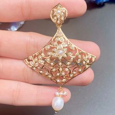 Featuring an intricately carved jadau pendant set in 22ct gold embellished with precious pearls. This rare design is sure to make a timeless impression on any ensemble. The pendant set weighs 17.75 GMs including 1.20 GMs of hanging pearls. Price Breakup Summary Component Rupees % of Total 22k Gold 87,725 79.5% Stones & Beads 3,660 3.3% Making Charges 15,791 14.3% Taxes (GST) 3,215 2.9% Total 110,391 100.0% View Detailed Price Breakup Here Jadau Pendant Set, Jadau Pendant, 22k Gold Jewelry Necklaces, Pendant Earrings Set, Pearl Pendant Earrings, 22k Gold Jewelry, Pearl Necklace Set, Gold Jewelry Necklace, Emerald Necklace