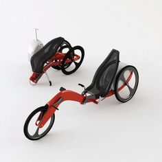 two red and black tricycles sitting side by side on a white surface with no wheels