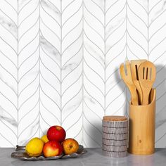 a wooden spatula sitting on top of a counter next to fruit