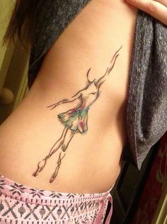 a woman's stomach with a tattoo on the side and an image of a ballerina