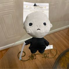 a stuffed doll with a key in it's hand and a harry potter costume on