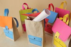 several small paper bags with different designs on them