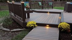 a deck lit up with lights and flowers