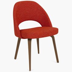 an orange upholstered chair with wooden legs and a red seat cover on the back