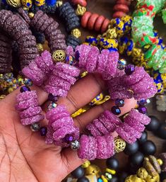 This handcrafted bracelet features Ghanaian Krobo Region recycled sugar crust beads, and African brass beads crafted through the time-honored "lost wax" technique. Its stretchy design and unique irregularities testify to its artisanal origin, making each a one-of-a-kind creation. Recycled sugar crust glass beads  100% Ashanti Brass Beads Hand Wrapped Heishi Beads For Gift, Handmade Beaded Bangle Bracelet For Healing, Bohemian Purple Beaded Bracelets With Large Beads, Handmade Heishi Beads Bangle Bracelet, Afrocentric Accessories, African Beaded Bracelets, African Brass Beads, Recycled Glass Bead, Handcrafted Bracelets