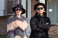 two people wearing hats and sunglasses standing next to each other