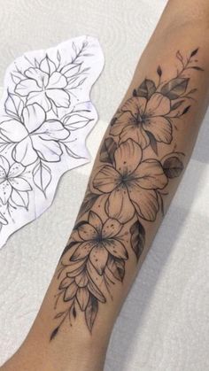 a woman's arm with flowers on it