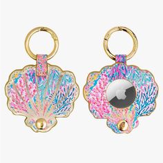 two keychains with colorful designs on them, one is gold and the other is pink