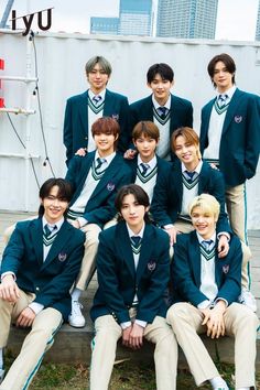 a group of young men sitting next to each other on top of a wooden bench