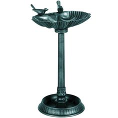 a metal fountain with a bird on it