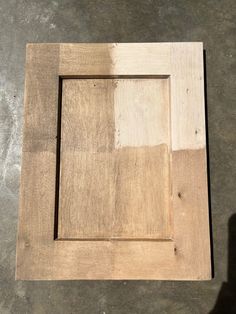 a square wooden frame sitting on top of a cement floor