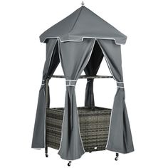 a gray and white canopy bed with curtains on the top, next to a wicker basket