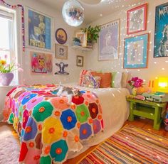 a bedroom decorated in bright colors with pictures on the wall