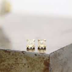 These tiniest ready to ship diamond stud earrings feature a pair of pale yellow / cream rose cut diamonds. They are made from solid 14k yellow gold and natural diamonds. Sisters Earrings are named after the similarities we share with each other. We are alike, but still unique. These tiny stud earrings are made with two gorgeous rose cut diamonds. The diamonds are similar enough to each other to form a pair, but are not completely identical. They are sisters, not twins. Two natural diamonds spark Delicate Diamond Earrings With Single Diamond For Gift, Delicate Single Diamond Earrings As A Gift, Dainty White Diamond Earrings With Single Stone, Minimalist White Diamond Earrings For Gift, Minimalist White Diamond Earrings Gift, Dainty White Diamond Earrings With Brilliant Cut, Dainty White Earrings With Single Diamond, Gift Yellow Gold Diamond Earrings With Single Cut, Delicate Diamond Cut Earrings For Gifts