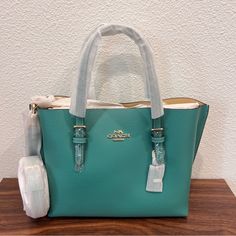 Color Green Vanilla Cream Double Face Leather Zip-Top Closure, Fabric Lining Side Open Compartments Handles With 4 3/4" Drop Detachable Strap With 22" Drop For Shoulder Or Crossbody Wear 9 3/4" (L) X 7 1/2" (H) X 4 3/4" (W) Style No. C4084 Green Tote Bags, Coach Mollie Tote, Coach Travel Bag, Coach Mollie, Coach Zip Top Tote, Paw Wallpaper, Canvas Leather Tote Bag, Leopard Tote, Coach Leather Bag