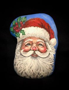 a close up of a santa claus face on a black background with holly berry decorations