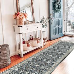 the entryway is decorated with baskets and flowers