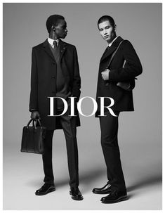 two men in suits standing next to each other with the words dior on them