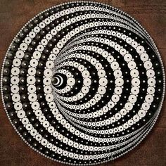 a black and white circular design on a brown tablecloth with circles in the center