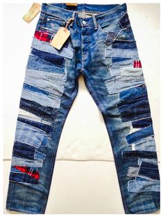 a pair of blue jeans with patches on them