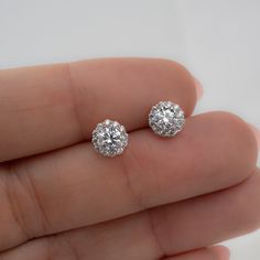 These cubic zirconia stud earrings featuring a pavé halo sparkle so bright! They are so elegant and work great for everyday first-hole studs or as wedding or bridesmaid earrings. Absolutely beautiful! We also use the highest grade of cz for an authentic diamond look! They look like real diamonds 🤩 Made of 925 Sterling Silver We use a THICK plating of 14k Gold or Rhodium Nickel-free & Hypoallergenic (safe for sensitive ears!) Sold as a pair 7mm Diameter Push-back closure 🎁 Comes in a gift-box, Dazzling Diamond White Cubic Zirconia Cluster Earrings, Dazzling Sterling Silver Cluster Earrings With Halo Design, Anniversary Round Cut Cubic Zirconia Cluster Earrings, Round Cut Cubic Zirconia Cluster Earrings For Formal Occasions, Elegant Cubic Zirconia Cluster Earrings With Halo Setting, Dazzling Cluster Earrings With Halo Design, Dazzling Cluster Earrings With Halo Setting For Formal Events, Sparkling White Gold Cluster Earrings With Cubic Zirconia, Dazzling Formal Cluster Earrings With Halo Setting