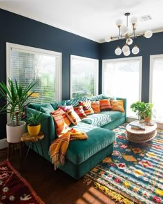 a living room with blue walls and green couches