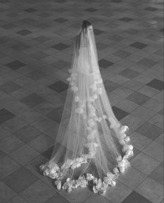 a woman in a wedding dress is standing on the floor with her veil over her head