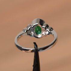 It is a lab emerald ring. The main stone is 6 mm*8 mm oval cut.weight about 1.13 carats. The basic metal is sterling silver and plated with rhodium. To change the metal to a solid gold (white/rose) or platinum is also available, please ask for a quotation if you want. You can also go to my shop Home for more elegant rings: https://www.etsy.com/shop/godjewelry?ref=hdr_shop_menu Emerald is the May birthstone More emerald rings: https://www.etsy.com/shop/godjewelry?section_id=20709240 Customization Green Oval Opal Ring With Bezel Setting, Elegant Green Opal Oval Ring, Emerald Oval Cabochon Ring For Anniversary & May Birthstone, Oval Emerald Birthstone Ring In White Gold, Fine Jewelry Emerald Oval Cabochon Promise Ring, Emerald Promise Ring With Polished Finish For May Birthstone, Oval Opal Ring For May Birthstone, Oval Emerald Ring With Bezel Setting For Promise, Elegant Silver Emerald Ring With Oval Cabochon