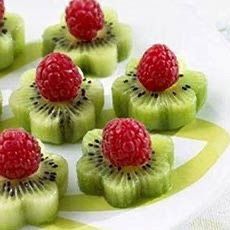 some kiwis with raspberries on top of them