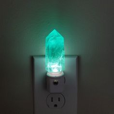 a light that is on the side of a wall with a green light in it