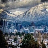 the city is surrounded by snow covered mountains