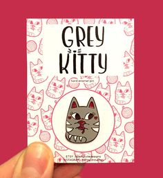 a hand holding up a card with a cat on it's face and the words grey kitty