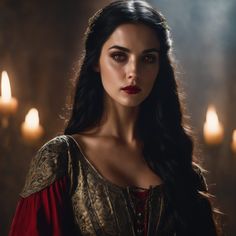 a woman with long black hair wearing a red dress in front of some lit candles