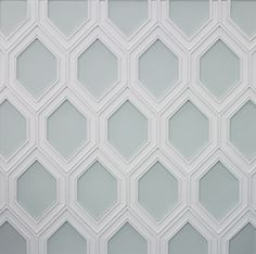 a white and gray wall with hexagonal shapes