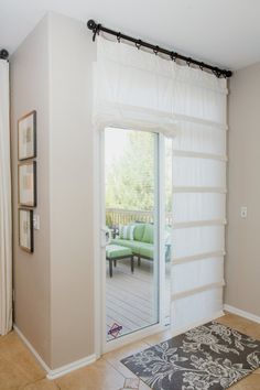 a living room with sliding glass doors leading to the patio