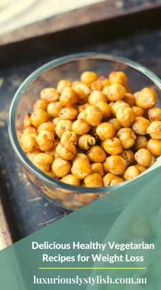 chickpeas in a glass bowl next to a salad