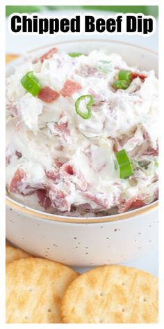 a bowl of dip with crackers on the side and text overlay that reads chipped beef dip