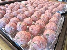 several trays of meatballs sitting on top of a counter