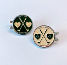 two green and gold golf themed cufflinks with crossed clubs and hearts on them