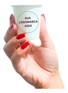 a woman's hand holding a coffee cup that says sua logamara aou