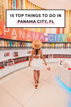 a woman in a white dress and straw hat walking through a store with the words top things to do in panama city, fl