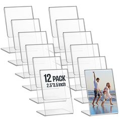 six clear acrylic display stands with two pictures on each side and one holding a child's hand