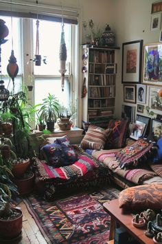 a living room filled with lots of furniture and plants on top of windowsills