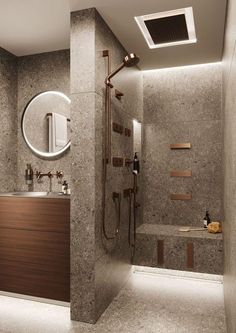 a bathroom with a sink, shower and bathtub next to a mirror on the wall