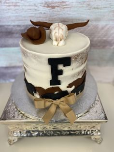 a cake with white frosting and brown decorations