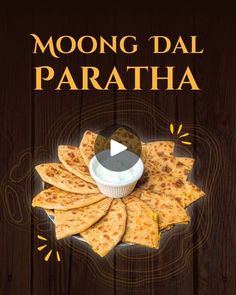 an advertisement for the moong dal paratha with cheese and sauce in it on a wooden background