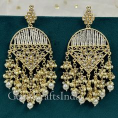 BEAUTIFUL KUNDAN JHUMKI EARRING *  Main Color : Gold * Skin Friendly : This Product does not contain harmful constituents. Anti-allergic safe for Skin. * Quality : Made from Premium Quality Material. This Product assures to remain in its Original Glory even after several usages.     . Actual Images of item are shown above, Please be aware of the actual colors may vary from the color shown on your screen, as monitor    settings may vary from individual to individual. . Welcome to Our Etsy Store! Festive Chandelier Earrings With Dangling Beads For Party, Traditional Pearl Earrings With Dangling Beads For Party, Festive Beaded Dangle Pearl Earrings, Festive Beaded Chandbali Chandelier Earrings, Dangling Beads Bridal Earrings For Celebration, Bridal Earrings With Dangling Beads For Celebration, Bridal Dangle Earrings With Dangling Beads, Traditional Beaded Earrings With Dangling Beads For Party, Festival Beaded Dangle Bridal Earrings