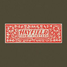 a red and white sign that says hayfield farm vineyard