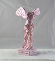 an angel statue on a pink pedestal in front of a white background with the words happy birthday